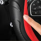 Black perforated leather steering wheel cover with red side seam stitching