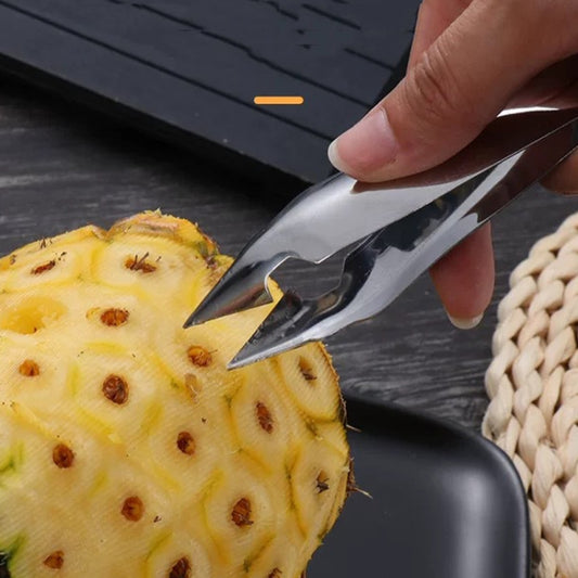 Stainless steel pineapple corer tool with pointed blade, used to remove core
