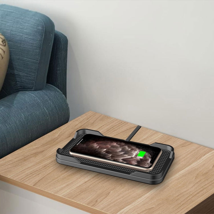 Car wireless charger on tabletop, dark gray pad with phone and green status indicator