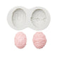 Silicone chocolate mold set with egg designs, showing two egg cavities and pink molded eggs