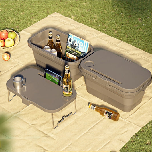 Folding picnic water carrier box with gray lid and handles, set on outdoor blanket