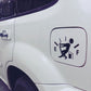 Close-up of white car fuel gauge icon reflective sticker with pump and arrow markings