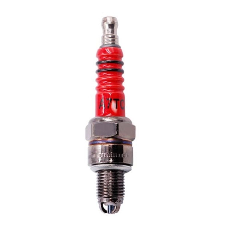 A7TC motorcycle spark plug with red insulator, hex nut, and threaded metal tip