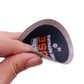 Hand holding a round tire repair patch disc, black label with 2-use