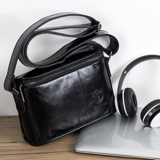 Black leather shoulder messenger bag with front zip pocket and adjustable strap