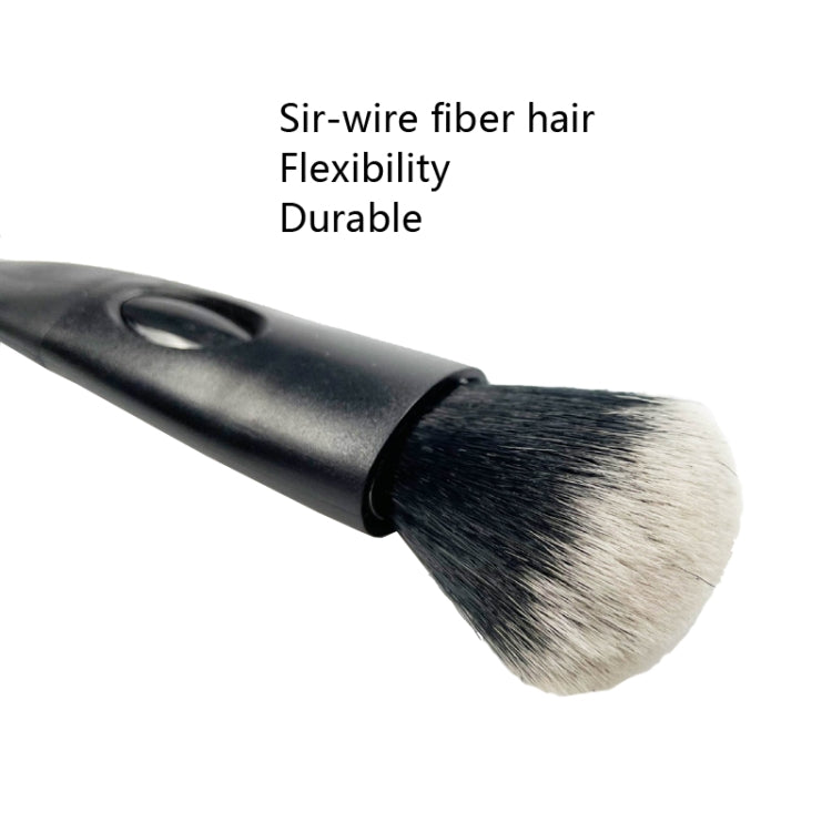 Detailing brush close-up with black handle and soft white bristle head