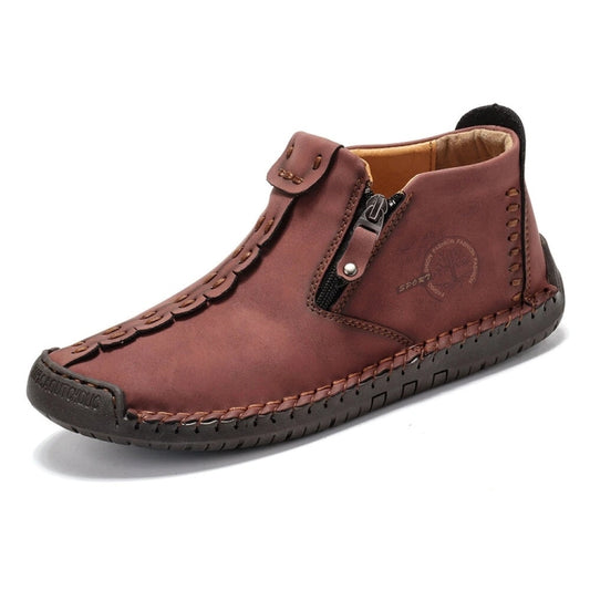 Men's casual ankle boots in dark brown with side zipper, buckle strap, and stitched trim