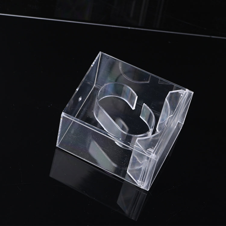Clear rectangular watch display box with cutout strap holders, angled view.