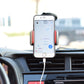 Phone mounted on black dashboard bracket with side clamps and charging cable