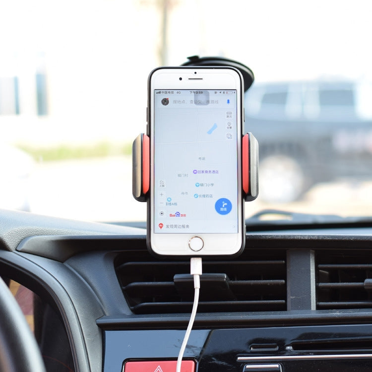 Phone mounted on black dashboard bracket with side clamps and charging cable