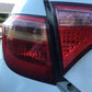 Car rear tail lights with red lens housings showing areas for patch repair
