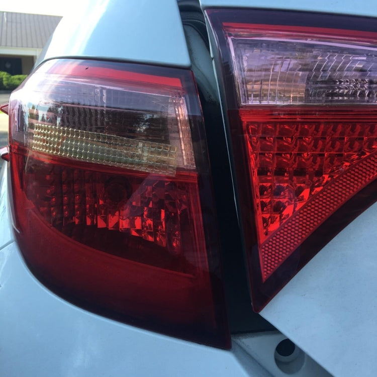 Car rear tail lights with red lens housings showing areas for patch repair