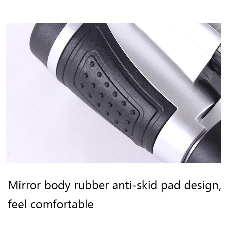 Silver binocular telescope close-up of textured anti-slip rubber grip on the body