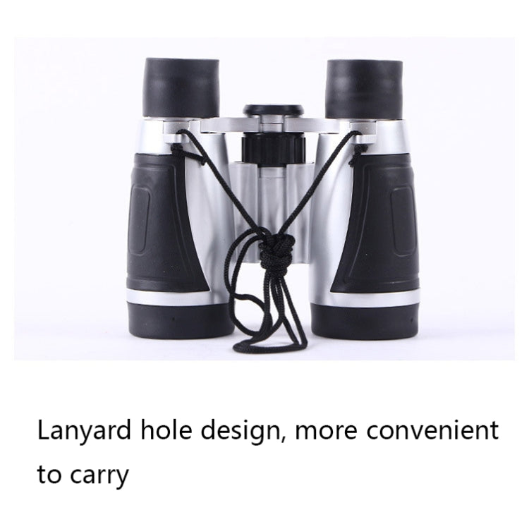 Silver binocular telescope with lanyard hole and attached hanging cord