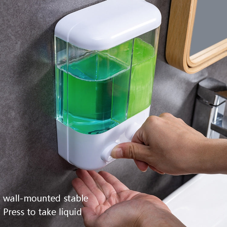 Wall-mounted manual soap dispenser with transparent reservoir and push button under hands