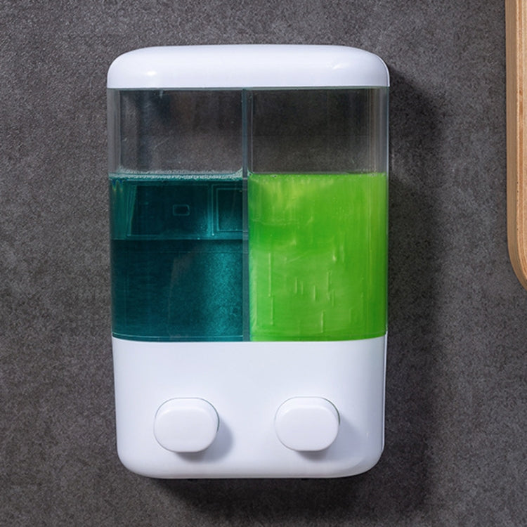 Wall-mounted manual soap dispenser with two push buttons and clear twin compartments
