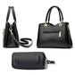 Black large handbag with top handles and side zipper, plus matching small wristlet pouch