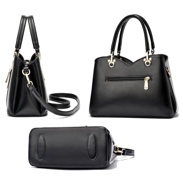Black large handbag with top handles and side zipper, plus matching small wristlet pouch