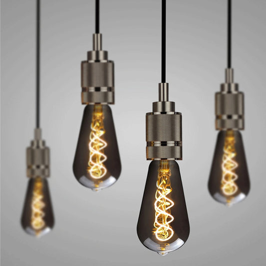 Set of hanging smoky grey retro LED bulbs with warm filament spirals and metal sockets