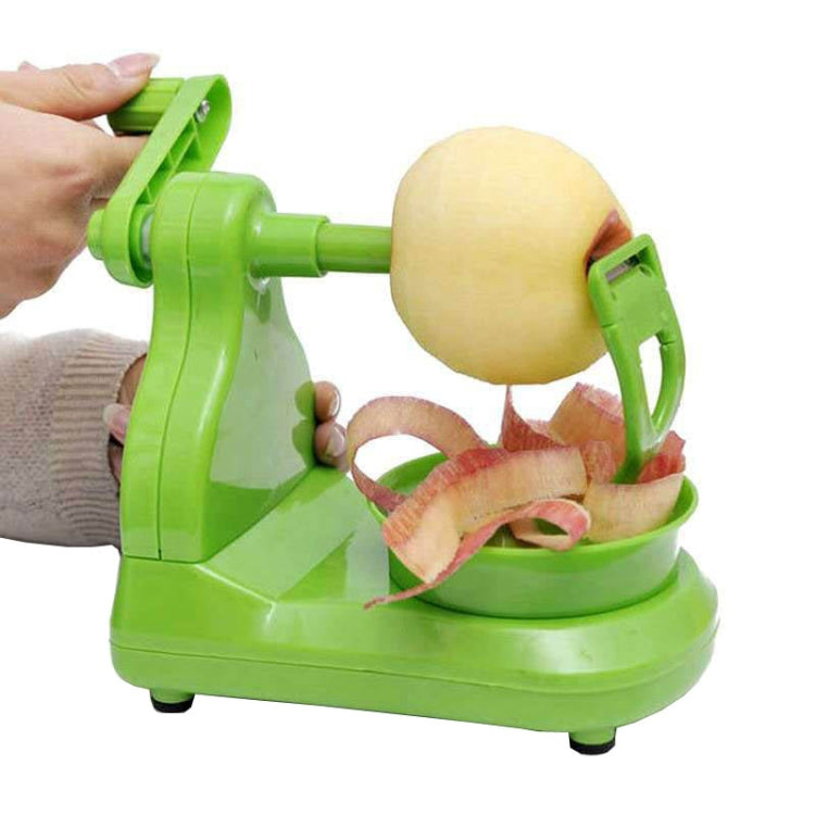 Green hand crank fruit peeler with peeling blade and melon on the holder