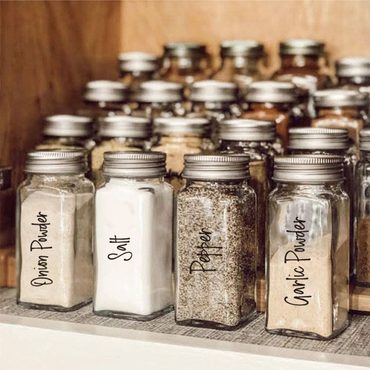 Transparent spice labels on glass spice jars, powder and flakes contents visible