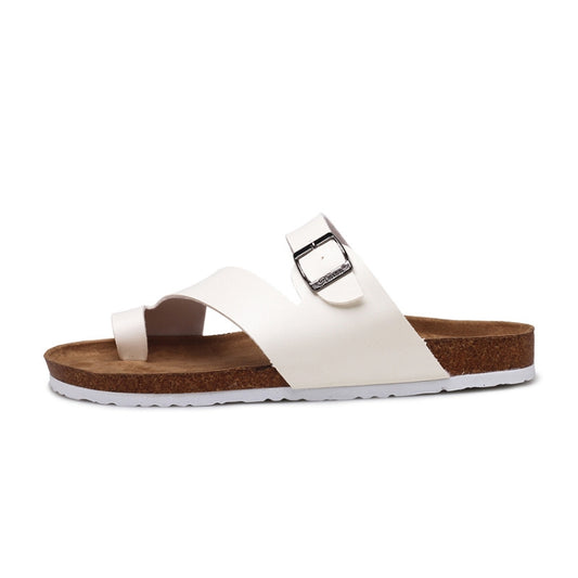 White cork slide sandals with open toe design, metal buckle, and foam cushioning