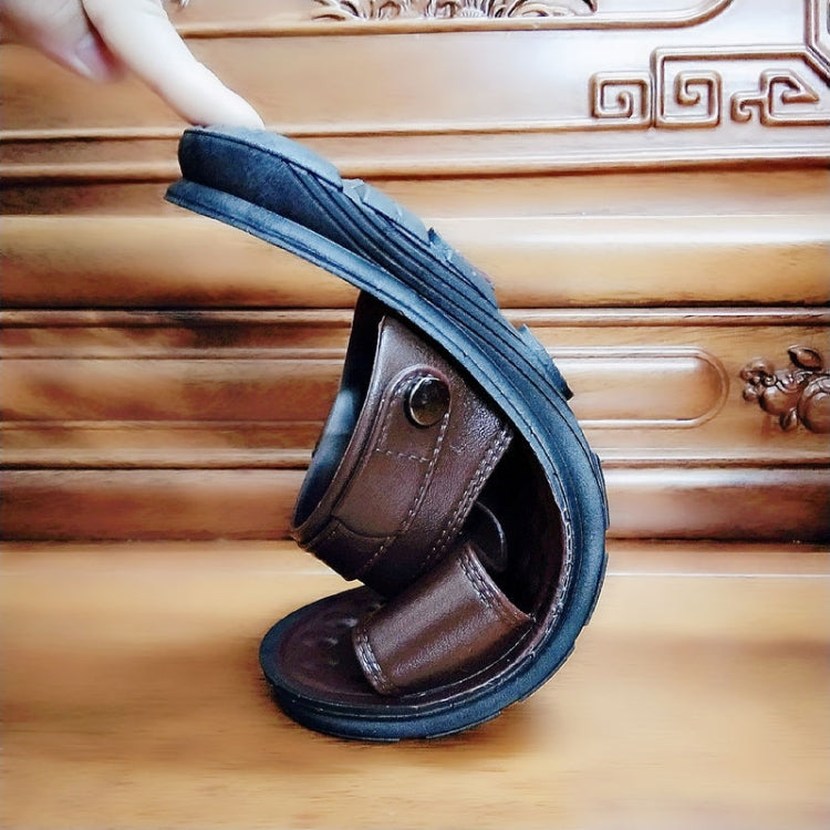 Brown men's sandals side view with two straps, circular buckle, and textured rubber sole