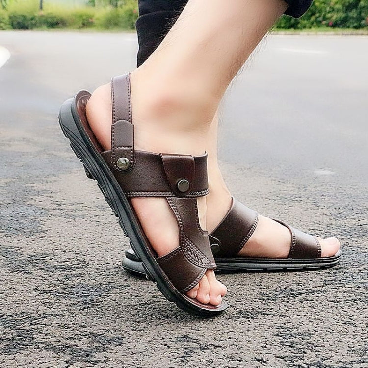 Men's brown leather-look slide sandals with ankle strap and circular buckle detail