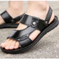 Men's black slide sandals with round metal buckles and textured outsole