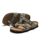 Grey cork slide sandals with two adjustable buckles and open toe, flat cushioned sole.