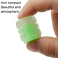 Luminous green split-effect tire valve cap held in hand, translucent translucent body