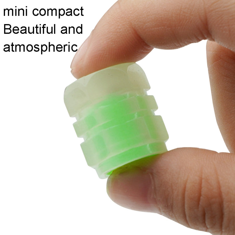 Luminous green split-effect tire valve cap held in hand, translucent translucent body