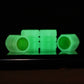 Set of 4 luminous green tire valve caps in a row, split-effect translucent body