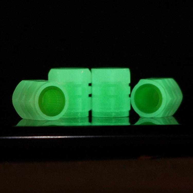 Set of 4 luminous green tire valve caps in a row, split-effect translucent body