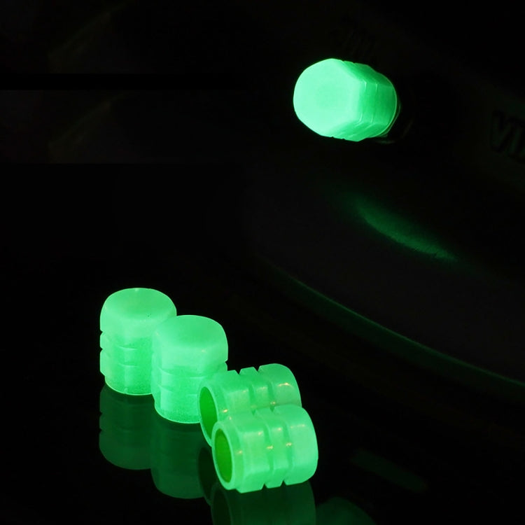 Luminous green split-effect tire valve caps glowing in the dark, set of 4