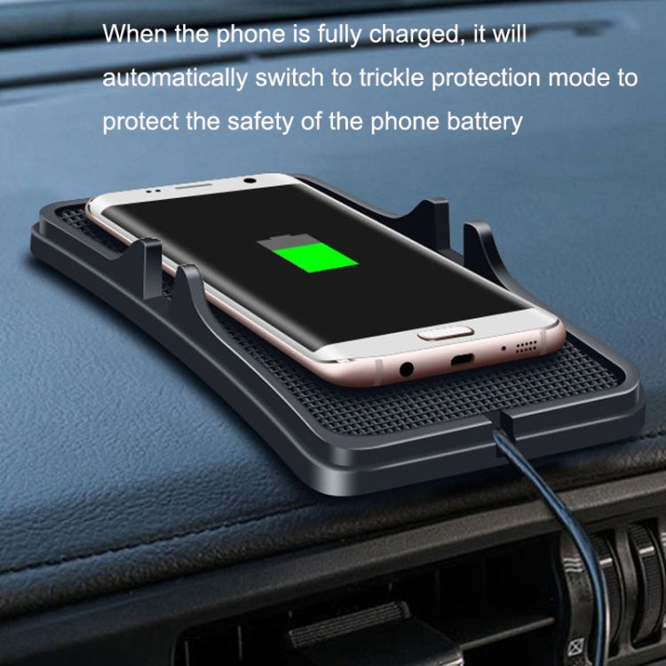 Wireless car charging pad with smartphone placed on dark car dashboard