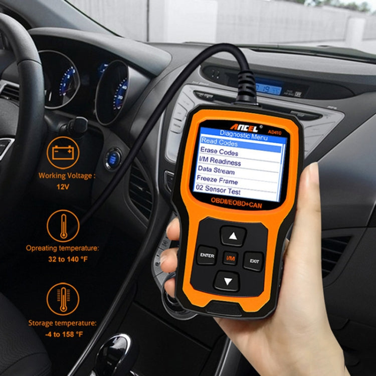 OBD2 scanner held near car dashboard showing Diagnostic Menu on orange screen