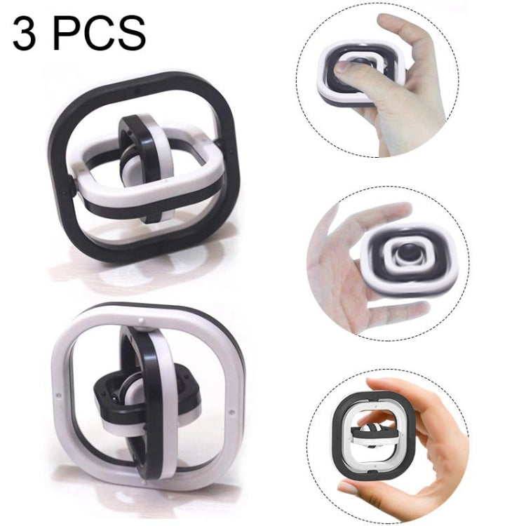 Set of 3 fingertip decompression flip toys, black and white, shown in hand