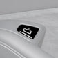 Close-up of car window switch sticker, black with white unlock icon