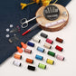 Sewing kit supplies on fabric: scissors, needles, safety pins, thimble, and colorful threads