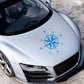 Blue compass rose graphic car sticker centered on a car hood