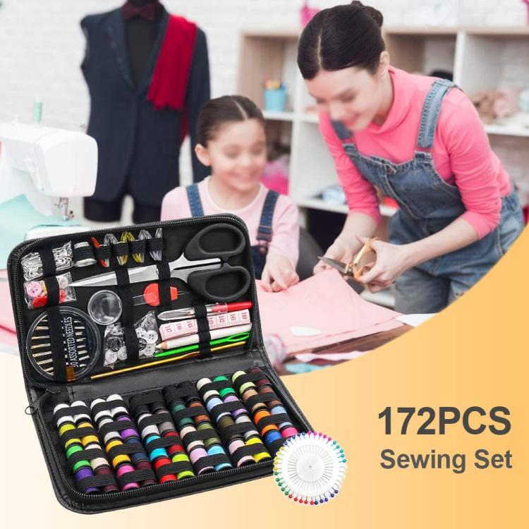 Sewing tool kit in open black case with scissors, spools, needles and threader