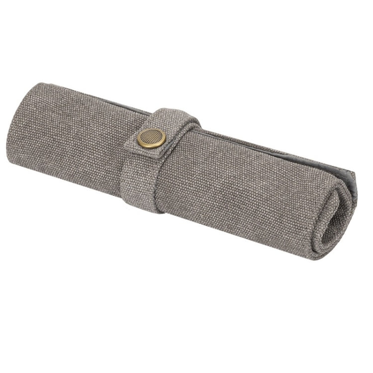 Grey nylon canvas watch strap storage bag, rolled with snap button closure.