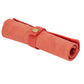 Orange nylon canvas watch strap storage bag, rolled with snap button closure.