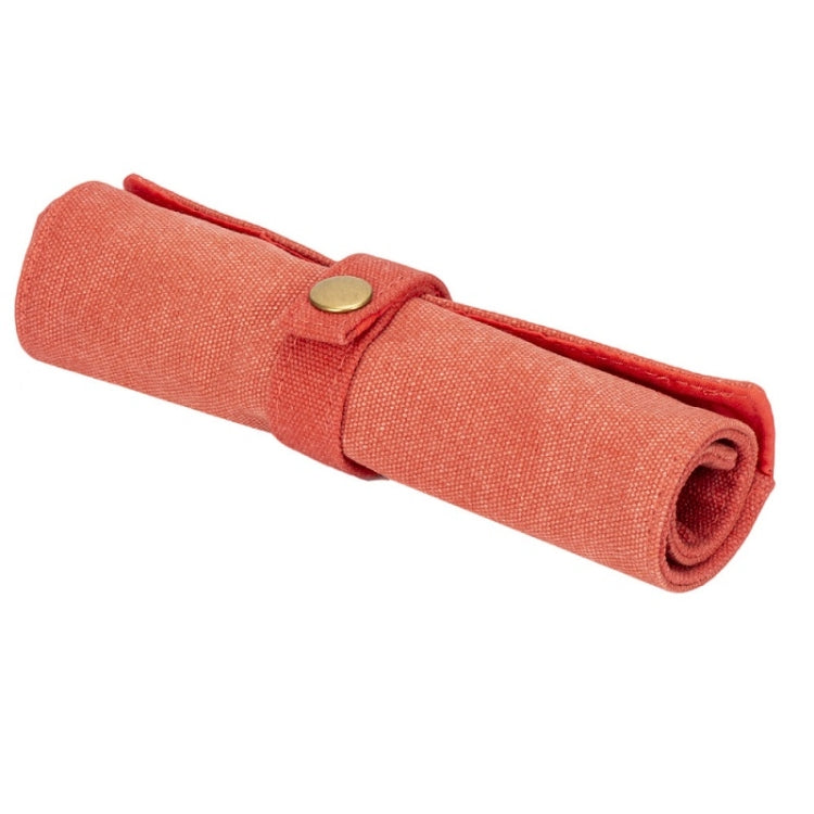 Orange nylon canvas watch strap storage bag, rolled with snap button closure.
