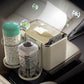 Beige car armrest storage box with tray holding cups, bottles, and small containers