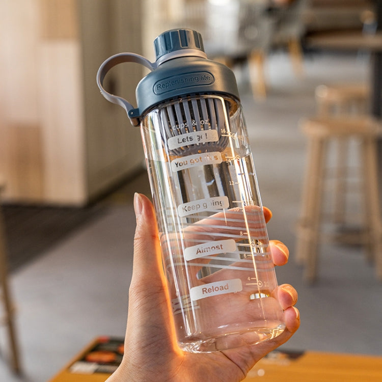 Clear plastic tea cup with blue lid and light handle