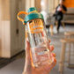 Handheld clear plastic tea cup with green lid and orange carry handle