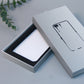 White phone case packaging box open with black insert tray