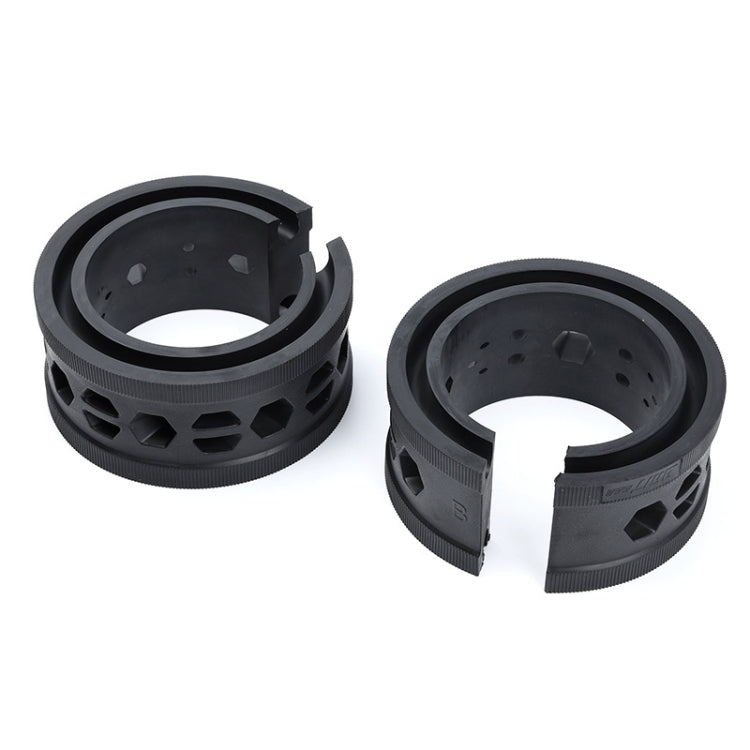 Two black rubber buffer rings separated, showing inner channel and side vent holes